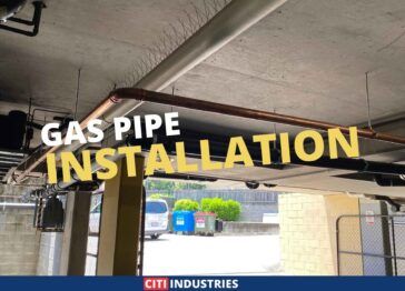 Gas pipe installation in a parking lot ceiling showcasing precision plumbing work.