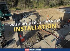 Washbay drainage system installation underway at an industrial vehicle maintenance facility in Carole Park Queensland, showing excavation and groundworks for collection pit and holding tank.