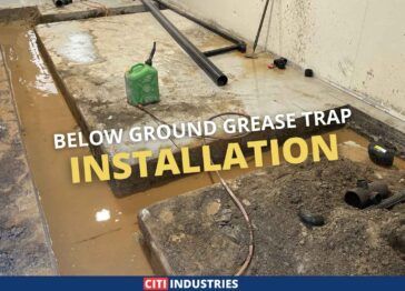 Below ground commercial grease trap installation in progress at a trade wastewater compliance project in Coopers Plains, Queensland, showing excavation and drainage pipework completed by Citi Industries.