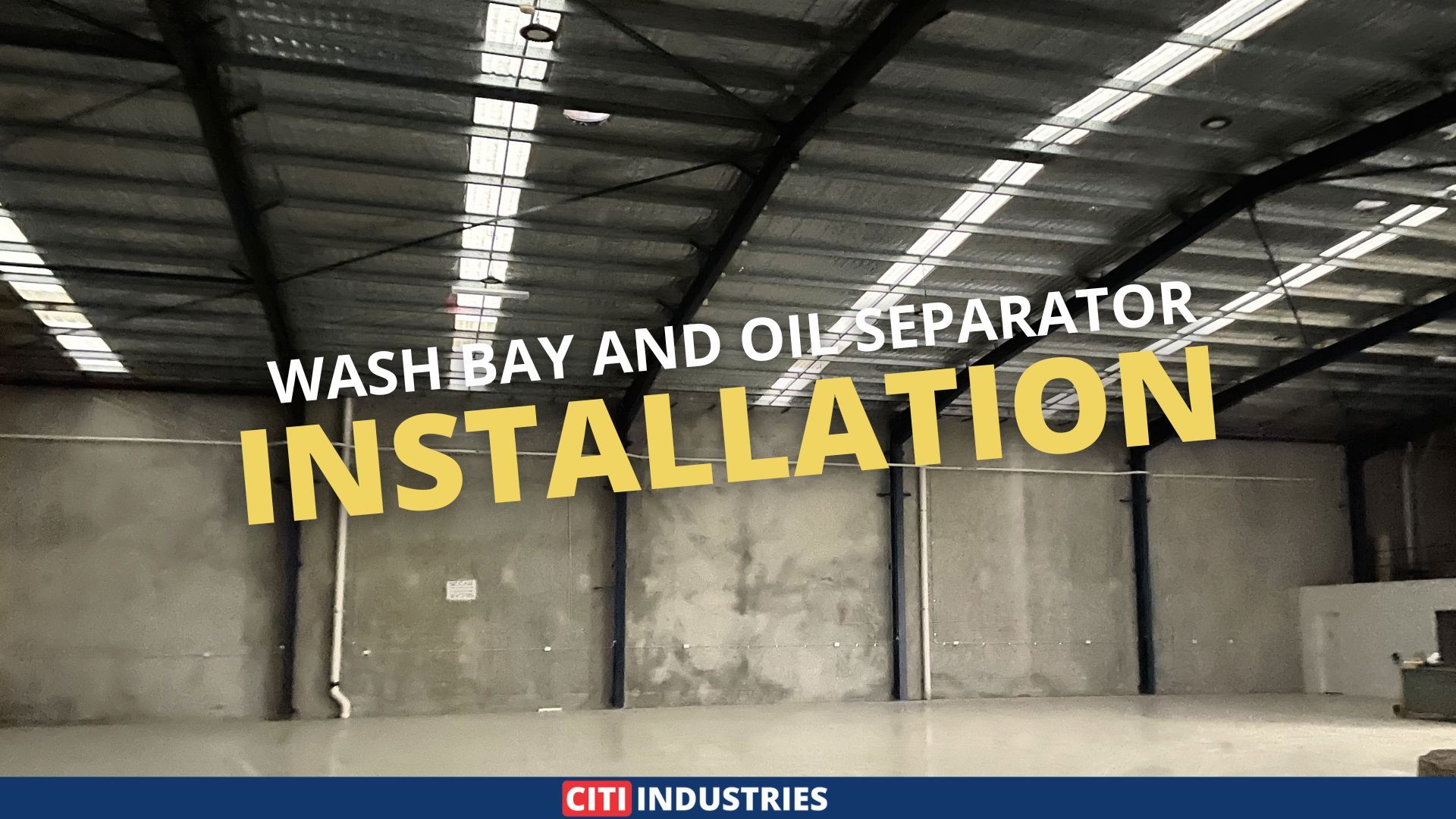Empty industrial warehouse interior with concrete floor and steel roof structure prepared for a wash bay and oil separator installation in Geebung, Queensland.